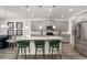 Open-concept kitchen with a large island, stainless steel appliances, and barstool seating at 939 Brittfield Way, Loganville, GA 30052