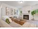 Bright living room features a fireplace, hardwood coffee table, and modern wall art at 939 Brittfield Way, Loganville, GA 30052