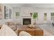 Bright living room features a fireplace, hardwood coffee table, and neutral decor at 939 Brittfield Way, Loganville, GA 30052