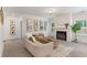 Inviting living room with a cozy fireplace, neutral tones, stylish decor and ample natural light at 939 Brittfield Way, Loganville, GA 30052