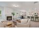 Comfortable living space offers a fireplace, plush seating, large windows, and kitchen view at 939 Brittfield Way, Loganville, GA 30052