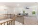 Open loft space with neutral carpet, large windows, and a comfortable sectional sofa at 939 Brittfield Way, Loganville, GA 30052