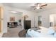 Bright main bedroom boasts modern decor, a ceiling fan, and sitting area at 939 Brittfield Way, Loganville, GA 30052