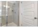 A glass shower stall with chrome shower head and door at 939 Brittfield Way, Loganville, GA 30052