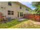 A view of a backyard with a small patio, grass, and a wooden fence at 3192 Spicy Cedar Lane Ln, Stonecrest, GA 30038
