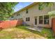A view of a backyard with a small patio, grass, and a wooden fence at 3192 Spicy Cedar Lane Ln, Stonecrest, GA 30038