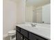 A bathroom with a white countertop, dark cabinets, and a large mirror reflecting the shower at 3192 Spicy Cedar Lane Ln, Stonecrest, GA 30038