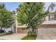Two-story townhome with attached garage, landscaping, and neutral siding at 3192 Spicy Cedar Lane Ln, Stonecrest, GA 30038