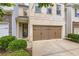 Well-maintained townhouse with attached garage, brick accents, and curb appeal at 3192 Spicy Cedar Lane Ln, Stonecrest, GA 30038