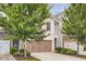 Two-story townhome with attached garage, brick accents, and mature trees at 3192 Spicy Cedar Lane Ln, Stonecrest, GA 30038