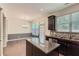 Stylish kitchen with dark cabinets, mosaic backsplash, and stainless steel dishwasher at 3192 Spicy Cedar Lane Ln, Stonecrest, GA 30038