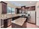 Modern kitchen featuring stainless steel appliances, granite countertops, and dark wood cabinets at 3192 Spicy Cedar Lane Ln, Stonecrest, GA 30038