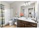 Bathroom featuring vanity with double sinks, a large mirror, and a shower-tub combo at 850 Ethereow Ct, Lawrenceville, GA 30046