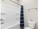 Bathroom featuring a tub-shower combo with a shower curtain and a white toilet at 850 Ethereow Ct, Lawrenceville, GA 30046