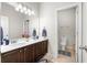 Bathroom with a double vanity and an adjoining closed-off toilet room, tiled floor at 850 Ethereow Ct, Lawrenceville, GA 30046