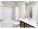 Bright bathroom featuring white bathtub and brown vanity at 850 Ethereow Ct, Lawrenceville, GA 30046