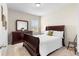 Bedroom with neutral carpet, a window, a bed, a dresser and decor at 850 Ethereow Ct, Lawrenceville, GA 30046