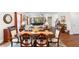 Bright dining area featuring a dark wood table and hardwood floors flowing into the open-concept living space at 850 Ethereow Ct, Lawrenceville, GA 30046