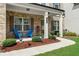 Inviting front porch with bright blue chairs, showcasing a cozy outdoor seating area and manicured landscaping at 850 Ethereow Ct, Lawrenceville, GA 30046