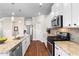 Updated kitchen featuring stainless steel appliances and stone countertops at 850 Ethereow Ct, Lawrenceville, GA 30046