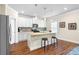 Kitchen with white cabinets, granite counters, stainless steel appliances, and wood floors at 850 Ethereow Ct, Lawrenceville, GA 30046
