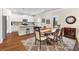 Open kitchen and dining space with white cabinetry, stainless appliances, and a granite island at 850 Ethereow Ct, Lawrenceville, GA 30046