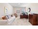 Living room with neutral carpet and paint, a window, couch, and desk with decor at 850 Ethereow Ct, Lawrenceville, GA 30046