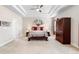 A spacious main bedroom with tray ceiling, ceiling fan, and a decorative accent wall hanging at 850 Ethereow Ct, Lawrenceville, GA 30046