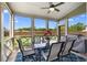 Screened patio with dining table, seating, ceiling fan, and views of the fenced yard at 850 Ethereow Ct, Lawrenceville, GA 30046