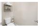 A small toilet room featuring toilet and minimalist shelving at 850 Ethereow Ct, Lawrenceville, GA 30046