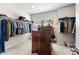 Spacious walk-in closet with ample shelving, hanging rods, and a dresser, offering optimal organization at 850 Ethereow Ct, Lawrenceville, GA 30046