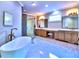 Bright bathroom featuring a soaking tub, dual vanity and glass enclosed shower at 913 Sunny Meadows Ln, Marietta, GA 30062