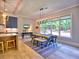 Bright dining room with a modern chandelier, a large window overlooking the backyard, and wood floors at 913 Sunny Meadows Ln, Marietta, GA 30062