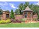 A beautiful brick entrance to Walton Creek Estates is surrounded by lush landscaping at 913 Sunny Meadows Ln, Marietta, GA 30062