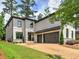 Beautiful two-story home with a brick driveway, and a 2-car garage at 913 Sunny Meadows Ln, Marietta, GA 30062