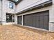 Spacious driveway leading to a three-car garage with custom doors and stone facade accents at 913 Sunny Meadows Ln, Marietta, GA 30062