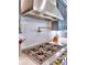 Close up of a range with custom tile and pot filler at 913 Sunny Meadows Ln, Marietta, GA 30062