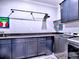 Modern laundry room features dark gray cabinets, granite countertops, and stainless steel appliances at 913 Sunny Meadows Ln, Marietta, GA 30062