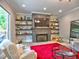 Bright living room with a stone fireplace, built-in shelves, and a vibrant red rug at 913 Sunny Meadows Ln, Marietta, GA 30062