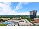 Panoramic aerial view of a cityscape, including a complex with a pool, lush greenery and large office building at 120 Ralph Mcgill Ne Blvd # 1409, Atlanta, GA 30308