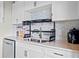 Close up of modern kitchen details with white cabinets and stylish backsplash at 120 Ralph Mcgill Ne Blvd # 1409, Atlanta, GA 30308