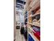 Inside of a laundry room with a stacked washer and dryer and ample shelving for organized storage at 120 Ralph Mcgill Ne Blvd # 1409, Atlanta, GA 30308