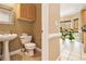 View of the half bathroom with tiled floors, pedestal sink, and white toilet at 317 Saint Pauls Ct, Stockbridge, GA 30281