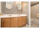 Bathroom featuring double vanity sinks and a shower with tiled walls at 317 Saint Pauls Ct, Stockbridge, GA 30281