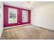 Cozy bedroom with two large windows and a bold accent wall at 317 Saint Pauls Ct, Stockbridge, GA 30281