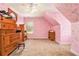 Pink attic bedroom with dressers and charming written walls at 317 Saint Pauls Ct, Stockbridge, GA 30281