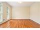 Sunlit bedroom with hardwood floors and three large windows at 317 Saint Pauls Ct, Stockbridge, GA 30281
