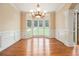 Elegant dining room with hardwood floors, wainscoting, and a bay window at 317 Saint Pauls Ct, Stockbridge, GA 30281