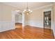 Formal dining room with hardwood floors, chandelier, and wainscoting details at 317 Saint Pauls Ct, Stockbridge, GA 30281