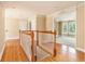 Upstairs hallway with hardwood floors, white trim, and lots of natural light at 317 Saint Pauls Ct, Stockbridge, GA 30281